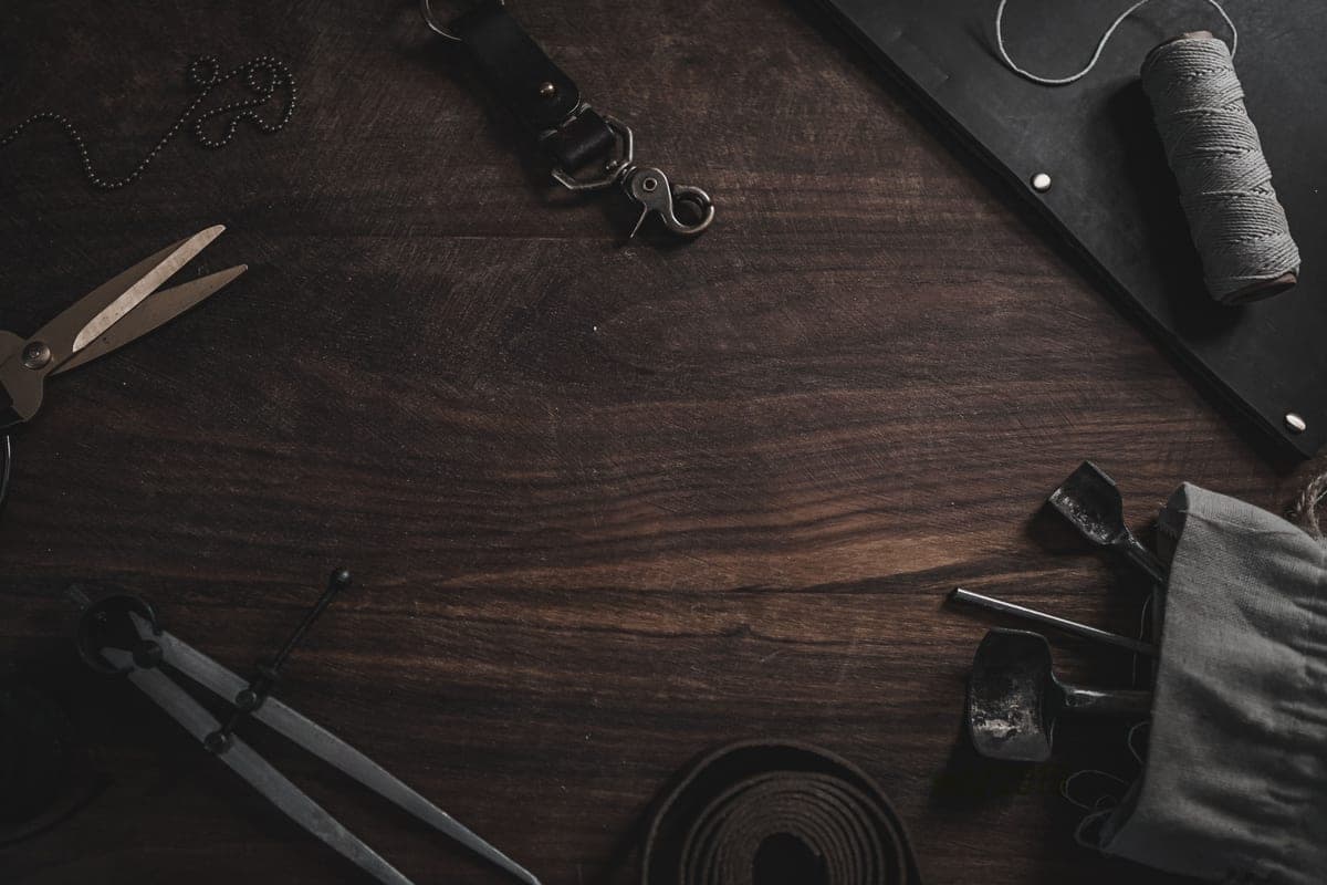 A craft workbench with scissors, tools and materials laid out