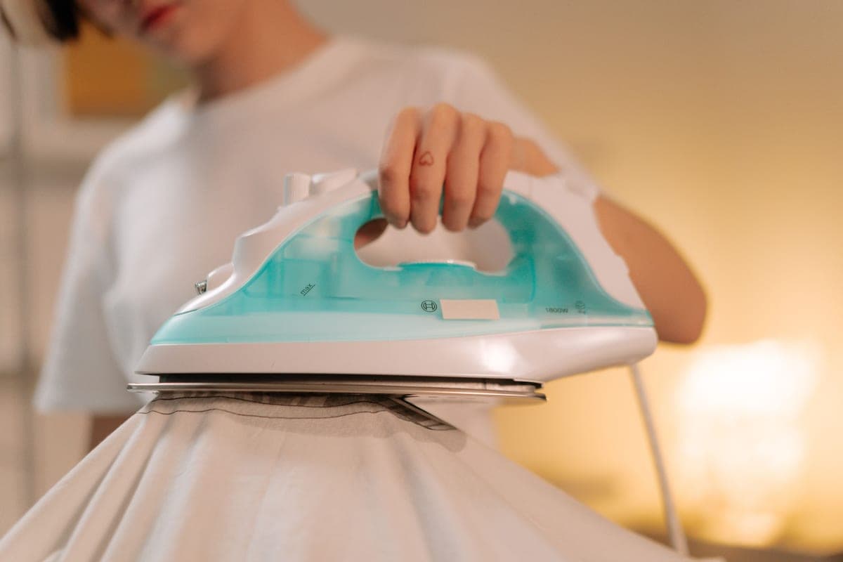 A clamshell heat press closed over a garment